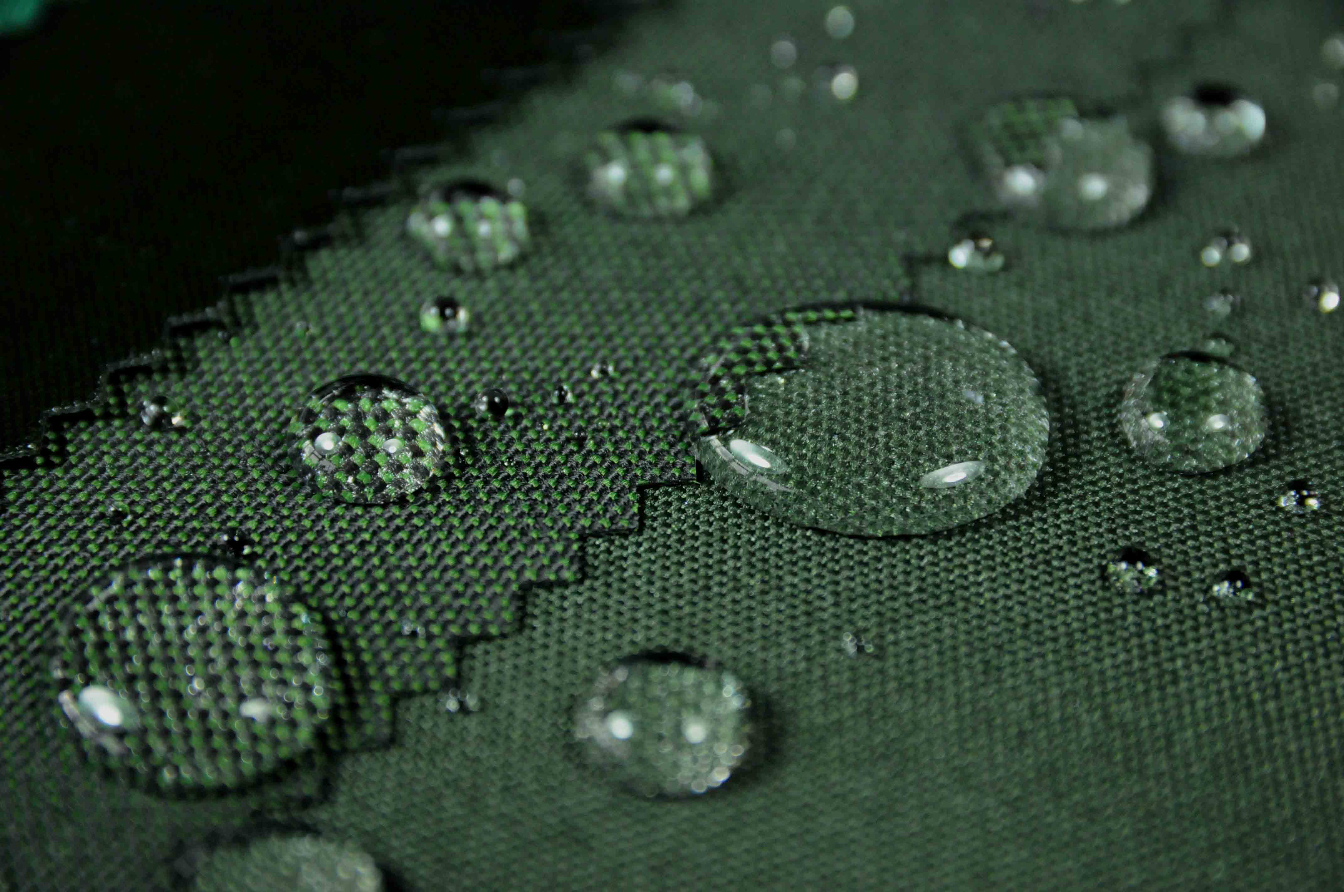 https://blog.fabricuk.com/wp-content/uploads/2018/05/green-fleck-waterproof-polyester-outdoor-fabric-testing-water-droplets.jpg