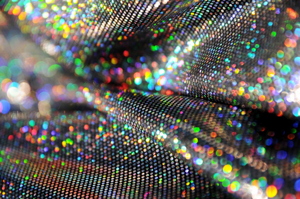 holographic dot computer foil fabric changing rainbow colours of the whole spectrum on sparkle stretch fabric for fashion rave wear 90s style hologram multicoloured stretch fabric